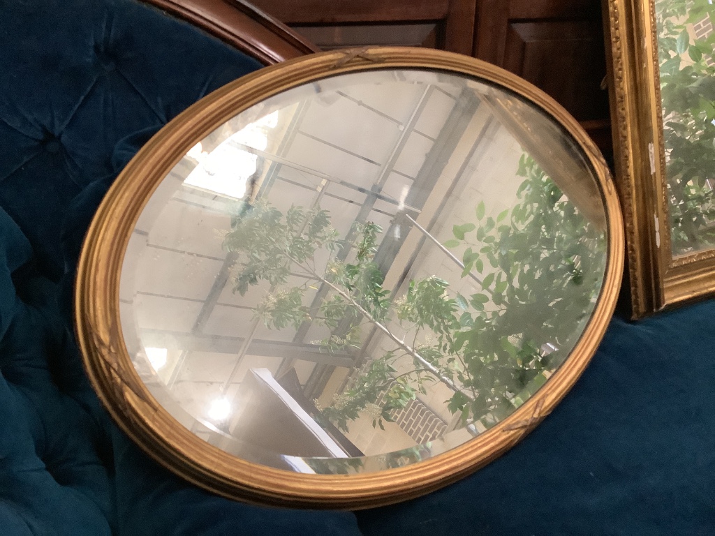 A rectangular gilt framed wall mirror, width 52cm, height 60cm, together with an oval gilt framed wall mirror